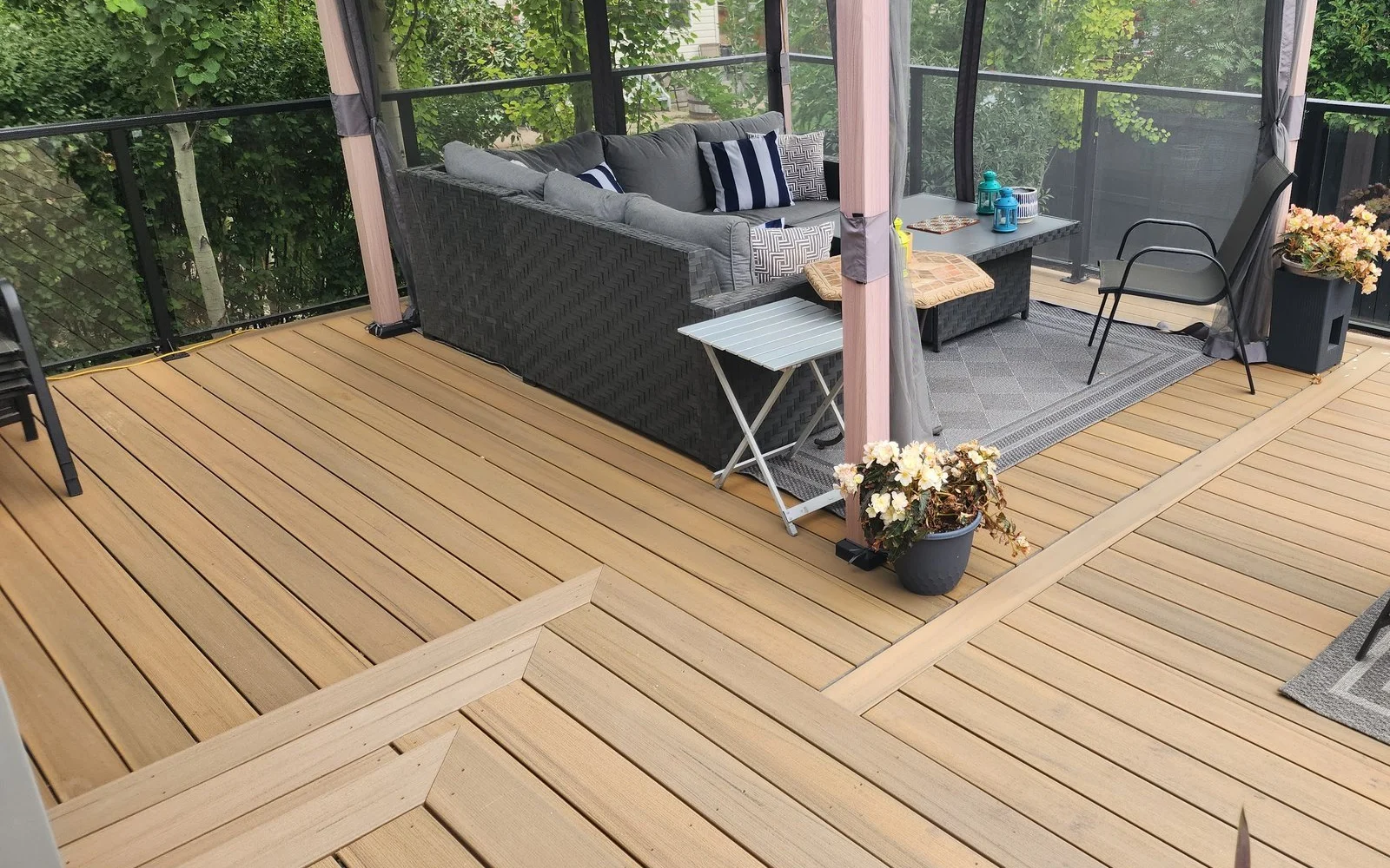 Composite deck with picture-frame borders and a furnished gazebo seating area
