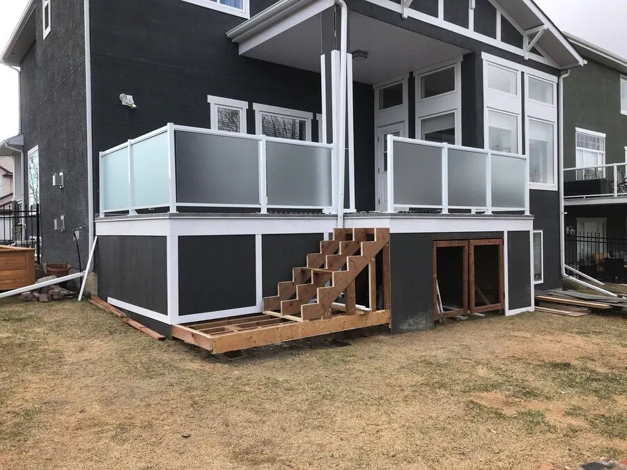 Elevated deck with glass guards, dark fascia and supporting posts